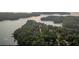 Aerial view of lakefront community with lush greenery at 124 Stonehouse Dr, Cumming, GA 30040