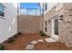 Small, private backyard with brick walls and patio at 124 Stonehouse Dr, Cumming, GA 30040