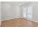 Bright and airy common room with hardwood floors and french doors at 124 Stonehouse Dr, Cumming, GA 30040