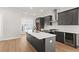 Modern kitchen with dark cabinetry, quartz countertops, and a large island at 124 Stonehouse Dr, Cumming, GA 30040