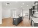 Modern kitchen with island, stainless steel appliances, and hardwood floors at 124 Stonehouse Dr, Cumming, GA 30040