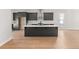 Modern kitchen with dark cabinetry, quartz countertops, and a large island at 124 Stonehouse Dr, Cumming, GA 30040