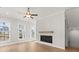Bright living room features hardwood floors, fireplace, and large windows at 124 Stonehouse Dr, Cumming, GA 30040