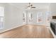 Bright living room features hardwood floors, fireplace, and large windows at 124 Stonehouse Dr, Cumming, GA 30040