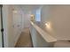 Upper hallway with carpet and doors to bedrooms at 35 Fontana Ct, Covington, GA 30016