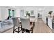 Bright dining area with marble-top table and chairs, open to the living room at 11190 Serenbe Ln, Chattahoochee Hills, GA 30268