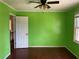 Green bedroom with hardwood floors and a window at 1193 Kelton Dr, Stone Mountain, GA 30083