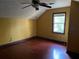 Yellow bedroom with hardwood floors and a window at 1193 Kelton Dr, Stone Mountain, GA 30083