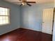 Light blue bedroom with hardwood floors and a window at 1193 Kelton Dr, Stone Mountain, GA 30083