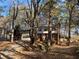 Two-story house nestled among mature trees with a long driveway at 1193 Kelton Dr, Stone Mountain, GA 30083
