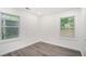 Bright bedroom with hardwood floors and two windows at 1846 Oakmont Nw Dr, Atlanta, GA 30314