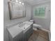 Bathroom featuring new vanity, a farmhouse sink, and marble countertops at 2082 Rainbow Dr, Snellville, GA 30039