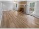 Light filled living room with brick fireplace, wood flooring, and neutral color palette at 2082 Rainbow Dr, Snellville, GA 30039
