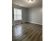 Bright bedroom featuring hardwood floors and window coverings at 16103 Waldrop Cv, Decatur, GA 30034