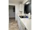 Kitchen with double sink, white cabinets, and view into dining area at 16103 Waldrop Cv, Decatur, GA 30034