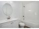 Modern bathroom with white vanity, oval mirror, and a shower/tub combo at 1685 Harbin Sw Rd, Atlanta, GA 30311