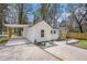 White house with carport, landscaping, and wooden fence at 1685 Harbin Sw Rd, Atlanta, GA 30311