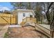 House exterior with wooden deck, stairs, and fenced yard at 1685 Harbin Sw Rd, Atlanta, GA 30311