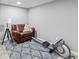 Relaxing basement area with recliner, rowing machine, and carpet at 2129 Lakeland Ct, Dacula, GA 30019