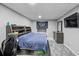 Basement bedroom with a double bed, gaming chair, and shelving at 2129 Lakeland Ct, Dacula, GA 30019