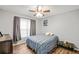 Cozy bedroom featuring a bed, window, and ceiling fan at 2129 Lakeland Ct, Dacula, GA 30019