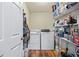 Laundry room with washer, dryer, and ample storage shelves at 2129 Lakeland Ct, Dacula, GA 30019