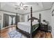 Main bedroom with a large bed, ceiling fan, and hardwood floors at 2129 Lakeland Ct, Dacula, GA 30019