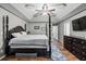 Main bedroom with large bed, dresser, and hardwood floors at 2129 Lakeland Ct, Dacula, GA 30019