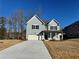 Two-story house with gray siding, a white garage door, and a covered porch at 4005 Riverchess Lot 127 Sw Dr, Atlanta, GA 30331