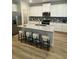 Modern kitchen with white cabinets and granite island at 4005 Riverchess Lot 127 Sw Dr, Atlanta, GA 30331