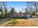 Gray house with red door, attached garage, and landscaping at 113 Hillmont Dr, Woodstock, GA 30188