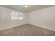 Bright bedroom with neutral walls, carpet, and a window with blinds at 1203 Sandune Dr, Norcross, GA 30093