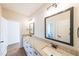 Bright bathroom featuring a double vanity with granite countertops, framed mirrors and modern lighting fixtures at 1330 Temple Draketown Rd, Temple, GA 30179