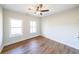 Cozy bedroom features hardwood flooring, a ceiling fan, and natural light from double hung windows at 1330 Temple Draketown Rd, Temple, GA 30179