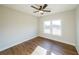 Bright bedroom featuring wood-look floors, neutral walls, a ceiling fan and a double window for natural light at 1330 Temple Draketown Rd, Temple, GA 30179