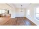 Dining room with modern chandelier, large windows, and wood flooring, adjacent to the kitchen at 1330 Temple Draketown Rd, Temple, GA 30179