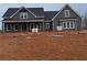 Gray farmhouse with covered porch, unfinished landscaping at 1330 Temple Draketown Rd, Temple, GA 30179