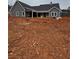 Rear view of gray farmhouse, unfinished landscaping at 1330 Temple Draketown Rd, Temple, GA 30179