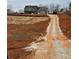 House from a distance, long driveway, unfinished land at 1330 Temple Draketown Rd, Temple, GA 30179