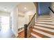 Inviting foyer featuring hardwood flooring, a coat rack and stairs with wooden treads and black iron railings at 1330 Temple Draketown Rd, Temple, GA 30179