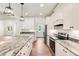 White kitchen with granite countertops and stainless steel appliances at 1330 Temple Draketown Rd, Temple, GA 30179