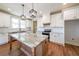 A well-lit kitchen featuring white cabinetry, a spacious island, and stainless steel appliances at 1330 Temple Draketown Rd, Temple, GA 30179