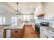 Modern kitchen featuring white cabinetry, granite countertops, stainless appliances, and pendant lighting at 1330 Temple Draketown Rd, Temple, GA 30179