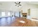 Bright living room featuring a stone fireplace, wood floors, and large windows for ample natural light at 1330 Temple Draketown Rd, Temple, GA 30179