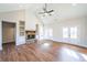 Spacious living room featuring a fireplace, wood flooring, and double doors leading to the outside at 1330 Temple Draketown Rd, Temple, GA 30179