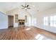 Spacious living room featuring hardwood floors, a stone fireplace, custom built-ins, and ample natural light at 1330 Temple Draketown Rd, Temple, GA 30179