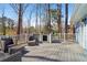 Outdoor deck with ample seating overlooks wooded yard at 201 Nouveau Sw Ct, Lilburn, GA 30047