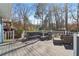 Back deck area with outdoor seating amid a wooded backyard at 201 Nouveau Sw Ct, Lilburn, GA 30047