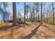 Expansive backyard with mature trees and a spacious deck, perfect for outdoor enjoyment at 201 Nouveau Sw Ct, Lilburn, GA 30047