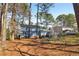 Large backyard with a beautiful two-story home and mature trees at 201 Nouveau Sw Ct, Lilburn, GA 30047